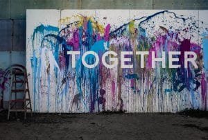 (image of people coming together): Stronger Together: Joining Hands for a Better Rotherham