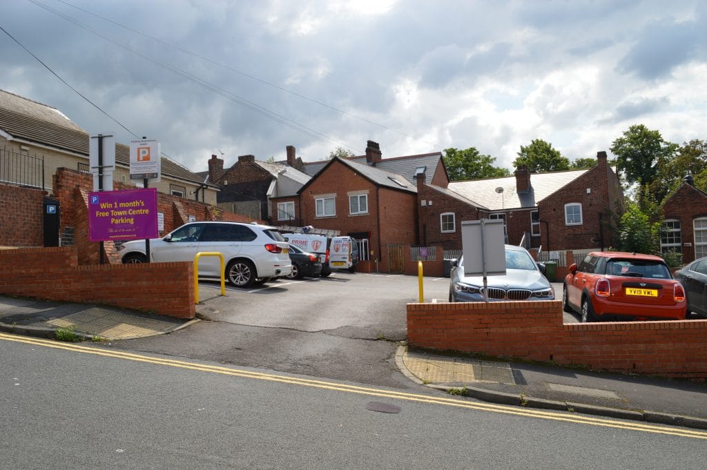 Purple sign with white text reading 'Best Car Park in Rotherham - Affordable and Safe Parking