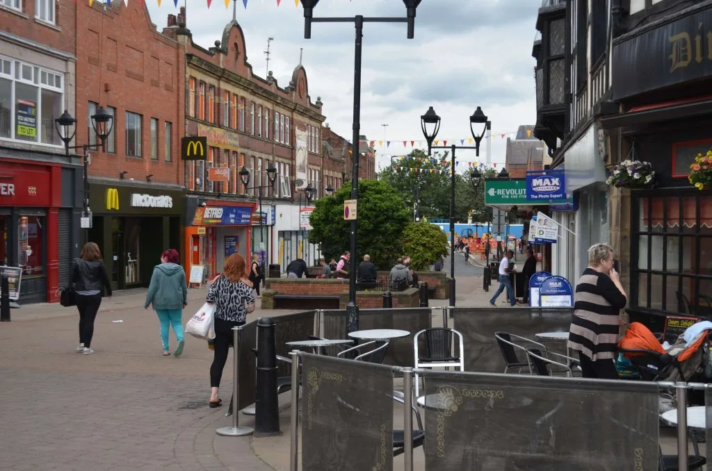 Busy people walking and shopping in central Rotherham on Moorgate street