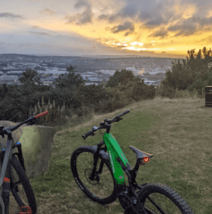 A photo of bicycles parked outside Boston Castle at sunset, with the beautiful countryside in the background