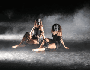 Young students with painted faces performing a dance at Rotherham College Performing Arts