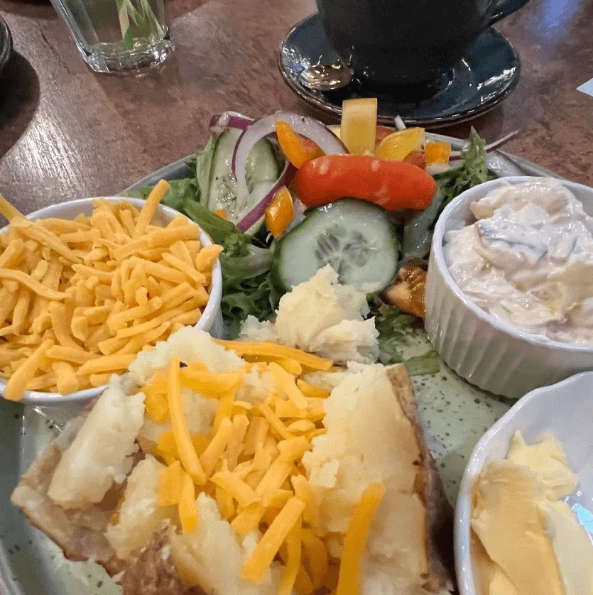 A mouth-watering spread of food including chips, baked potatoes, and vegetables in Rotherham